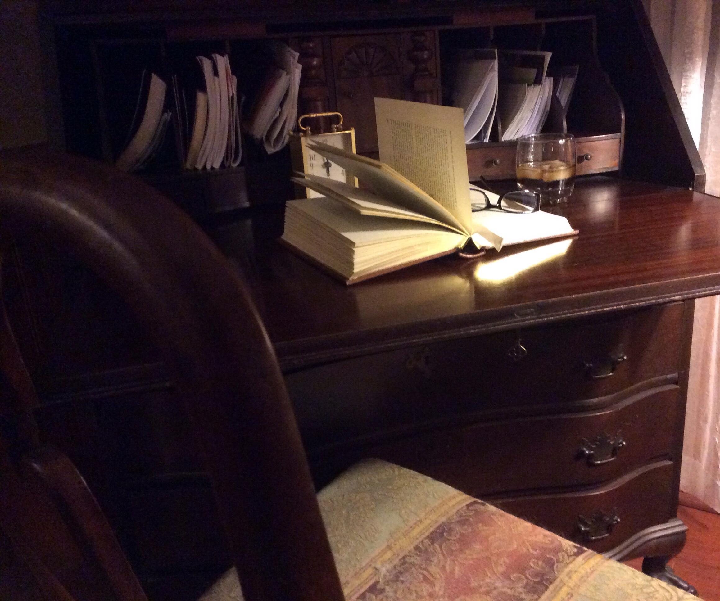 book on desk with glasses