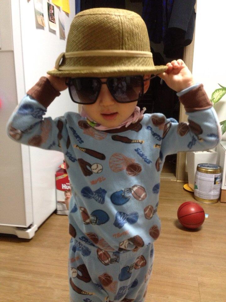 child in hat and glasses